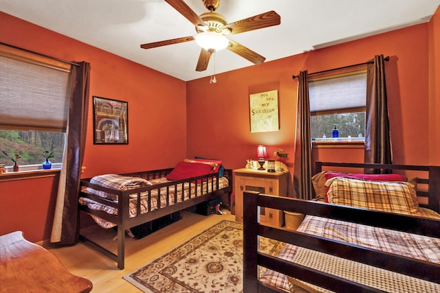 bedroom with ceiling fan and light hardwood / wood-style flooring