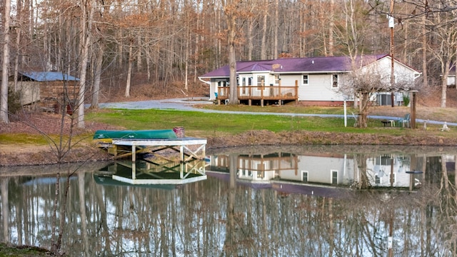 view of dock with a water view and a yard