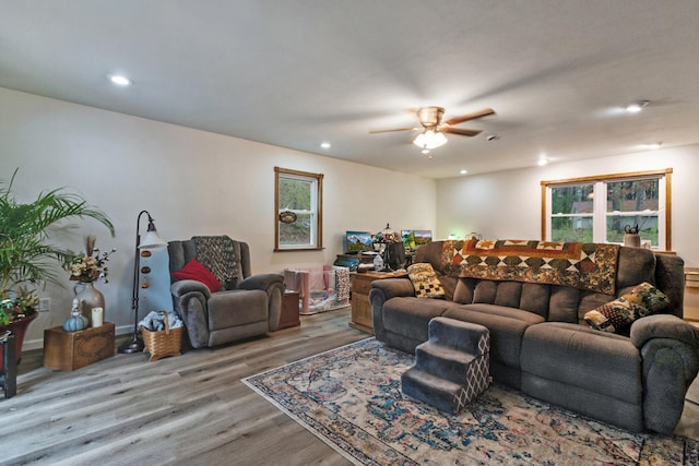 living room featuring light hardwood / wood-style flooring and ceiling fan