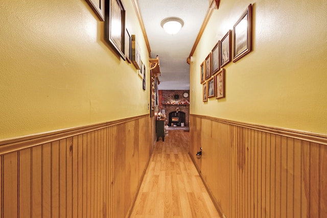 hall featuring light hardwood / wood-style floors and crown molding