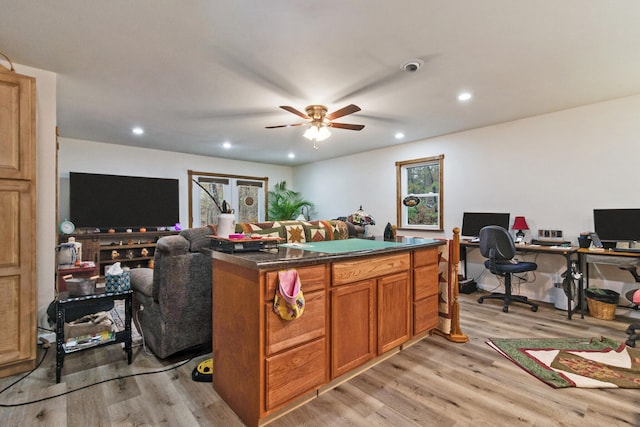 kitchen with ceiling fan, a center island, plenty of natural light, and light wood-type flooring