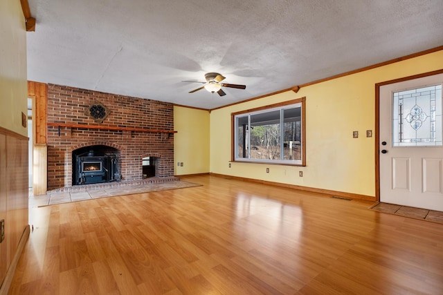 unfurnished living room featuring light wood-style flooring, visible vents, ornamental molding, and a textured ceiling