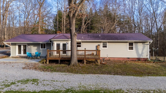 back of house featuring french doors, a patio, crawl space, metal roof, and a deck