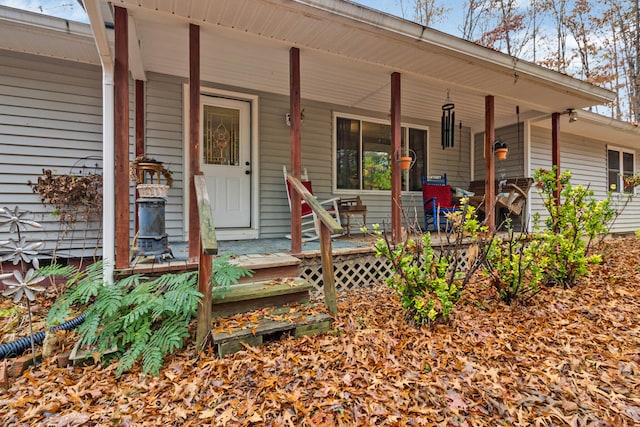 view of exterior entry with a porch