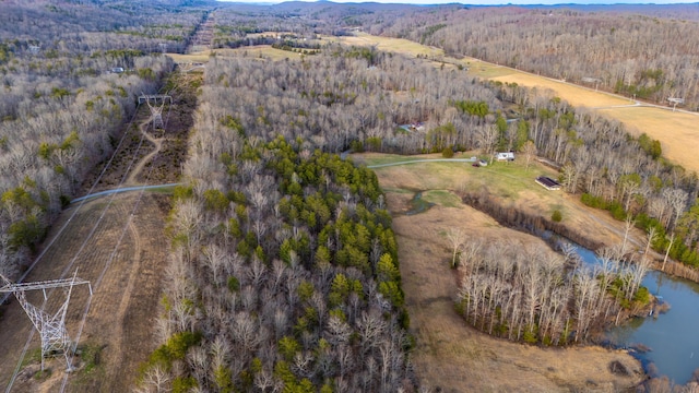 drone / aerial view with a water view and a forest view