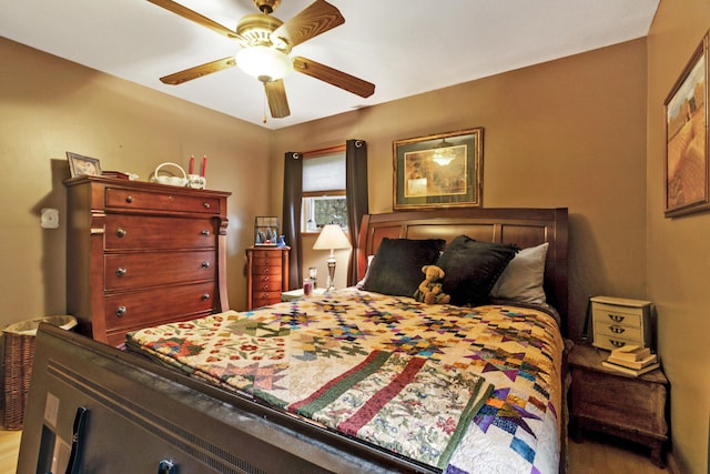 bedroom with hardwood / wood-style floors and ceiling fan