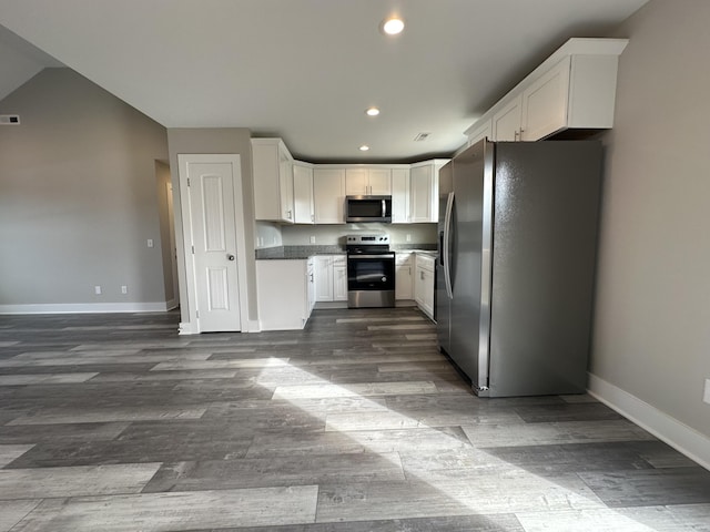 kitchen featuring appliances with stainless steel finishes, dark hardwood / wood-style flooring, and white cabinets