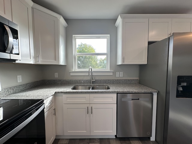 kitchen featuring appliances with stainless steel finishes, sink, and white cabinets