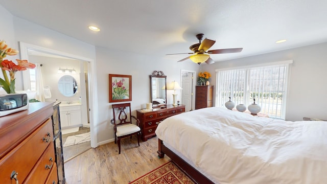 bedroom with ceiling fan, connected bathroom, and light wood-type flooring