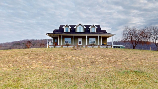 view of front facade with covered porch and a front yard