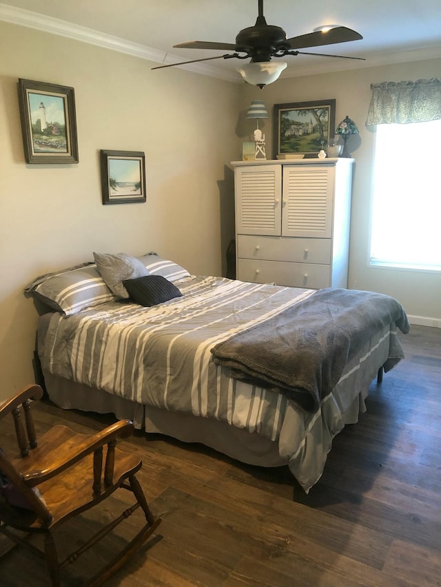 bedroom featuring ceiling fan, crown molding, and dark wood-type flooring