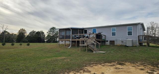 back of house with a lawn, a wooden deck, a sunroom, and central AC unit