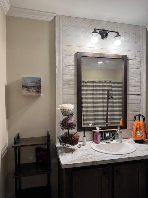 bathroom with vanity and ornamental molding