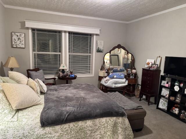 bedroom featuring a textured ceiling, carpet floors, and ornamental molding