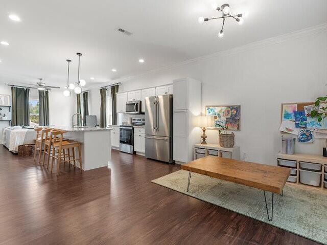 1323 Chippewa Ave SE, Cleveland, TN 37311 - kitchen featuring appliances with stainless steel finishes, ornamental molding, recessed lighting, a chandelier, and dark wood-style floors