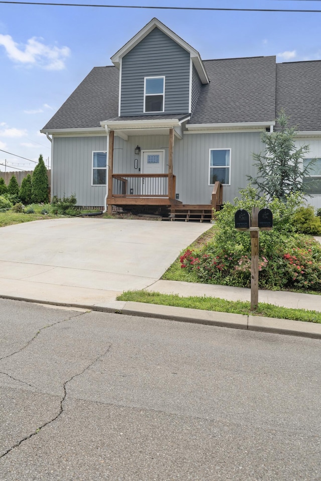 1323 Chippewa Ave SE, Cleveland, TN 37311 - view of front facade with covered porch, a shingled roof, board and batten siding, and driveway