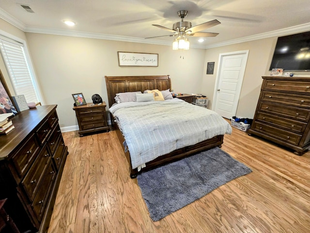 bedroom with ceiling fan, light hardwood / wood-style floors, and ornamental molding