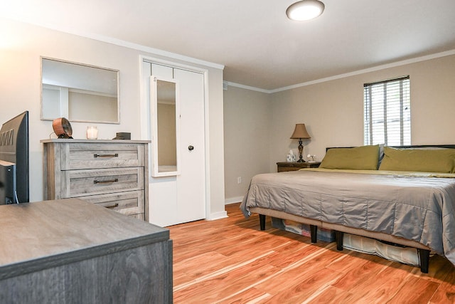 bedroom featuring a closet, crown molding, and light hardwood / wood-style flooring