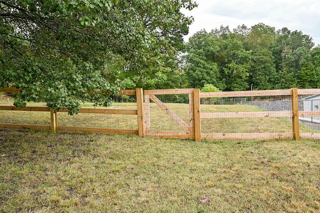 view of gate with a yard