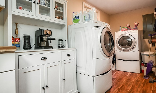 laundry area with washer and dryer, dark hardwood / wood-style floors, and cabinets