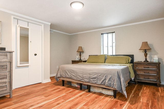 bedroom with crown molding and light hardwood / wood-style flooring