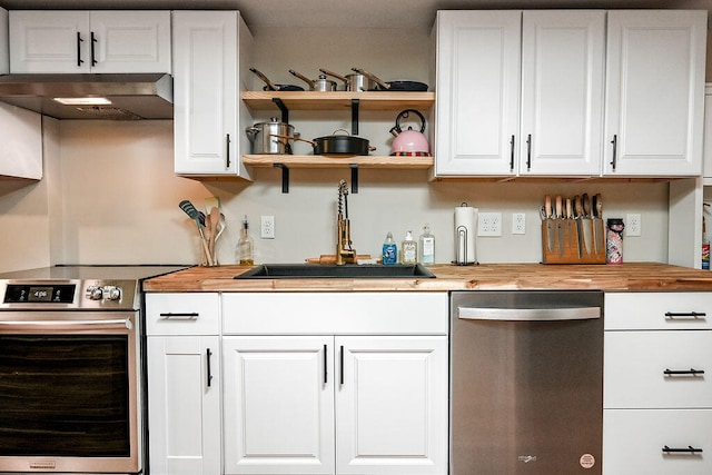 kitchen with ventilation hood, white cabinetry, stainless steel appliances, and butcher block counters