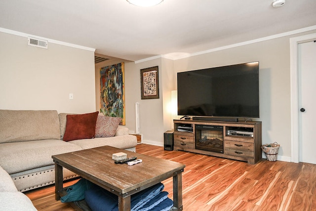 living room with hardwood / wood-style floors and crown molding