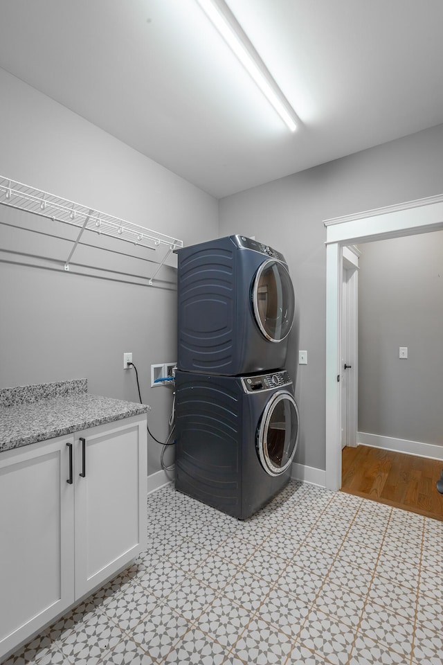 laundry room with stacked washer / drying machine