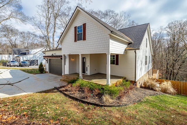 view of front of property with a garage and a front lawn