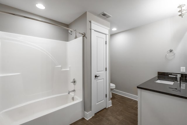 full bathroom featuring vanity, washtub / shower combination, and toilet