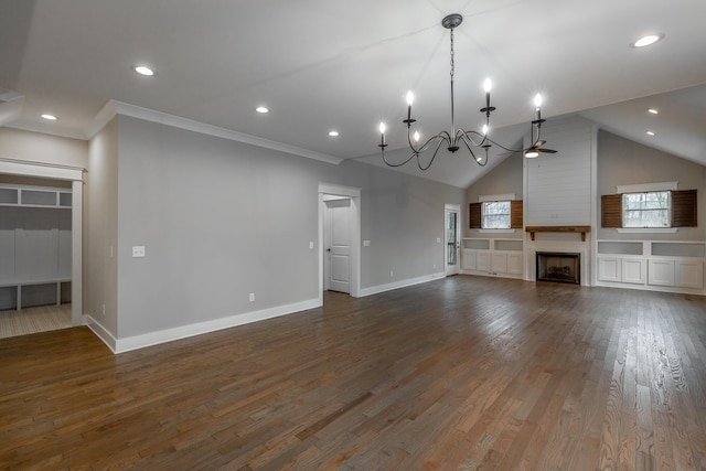 unfurnished living room featuring vaulted ceiling, dark hardwood / wood-style floors, a fireplace, ornamental molding, and a notable chandelier