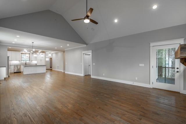 unfurnished living room featuring hardwood / wood-style flooring, high vaulted ceiling, sink, and ceiling fan with notable chandelier