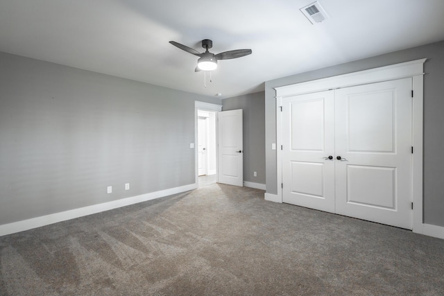 unfurnished bedroom with ceiling fan, a closet, and carpet