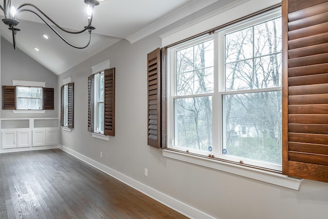 unfurnished dining area featuring ornamental molding, lofted ceiling, and dark hardwood / wood-style flooring