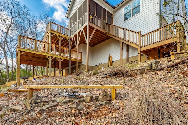 rear view of house featuring a sunroom