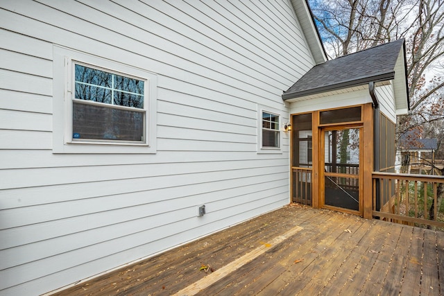 wooden deck featuring a sunroom