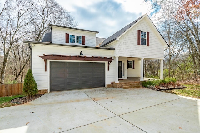 view of front of home featuring a porch and a garage