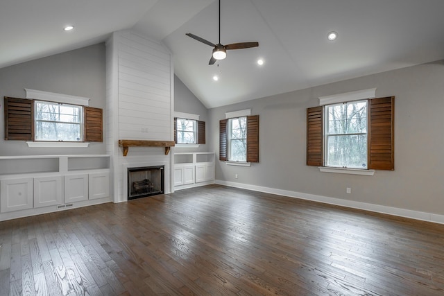 unfurnished living room featuring dark hardwood / wood-style floors, ceiling fan, a fireplace, and high vaulted ceiling