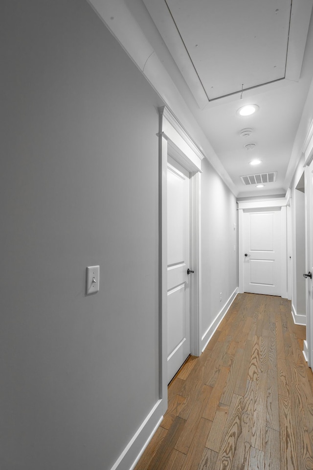 hallway with light hardwood / wood-style flooring