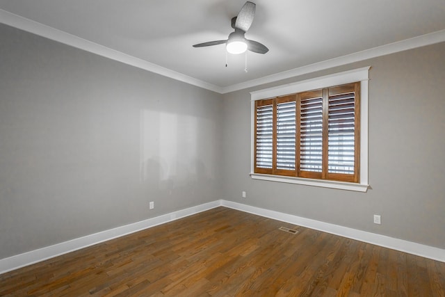 spare room with dark hardwood / wood-style flooring, ornamental molding, and ceiling fan