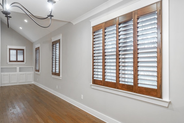 unfurnished dining area featuring crown molding, lofted ceiling, and dark wood-type flooring