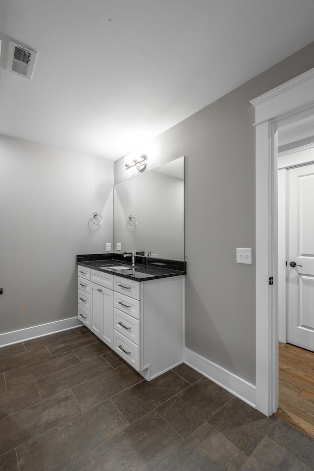 bathroom with vanity and wood-type flooring