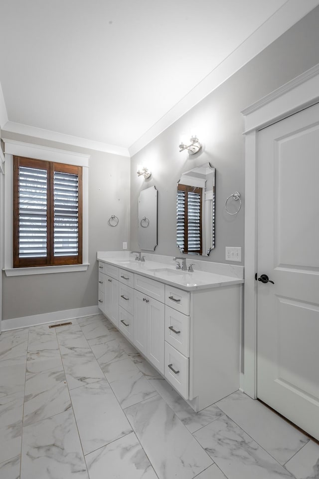 bathroom featuring ornamental molding and vanity