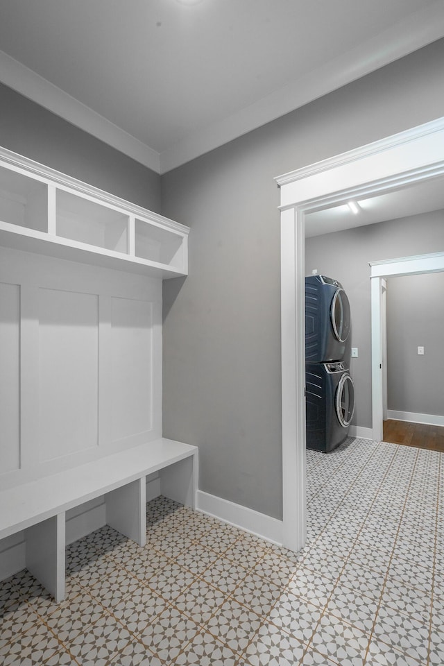 mudroom featuring stacked washer / dryer