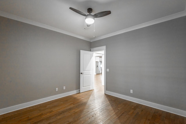 empty room with crown molding, wood-type flooring, and ceiling fan