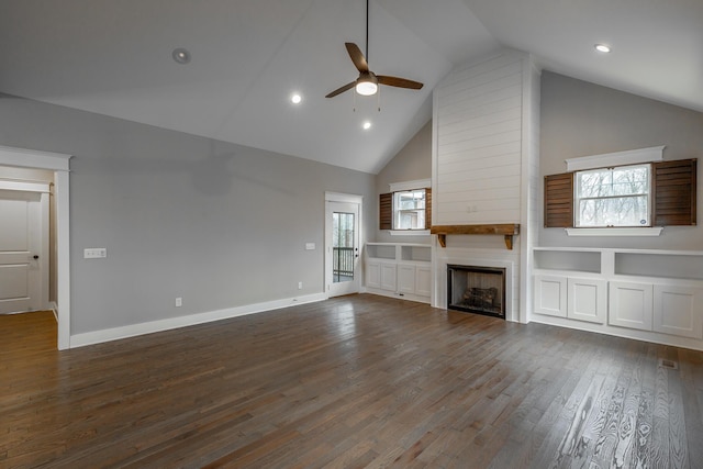 unfurnished living room featuring ceiling fan, high vaulted ceiling, dark wood-type flooring, and a fireplace