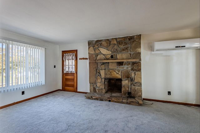 unfurnished living room featuring a fireplace, carpet floors, and an AC wall unit