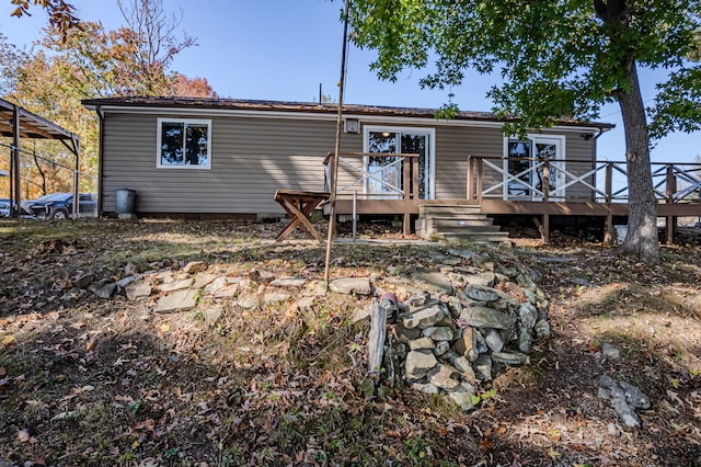 back of house featuring a deck