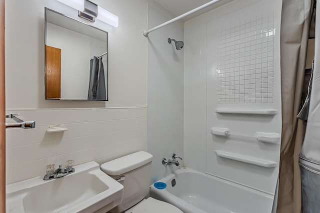 full bathroom with sink, shower / bathtub combination with curtain, tile walls, and toilet