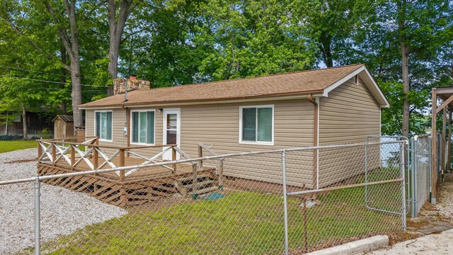 1336 Whites Creek Rd, Spring City, TN 37381 - ranch-style house featuring a chimney, a wooden deck, roof with shingles, and a storage shed